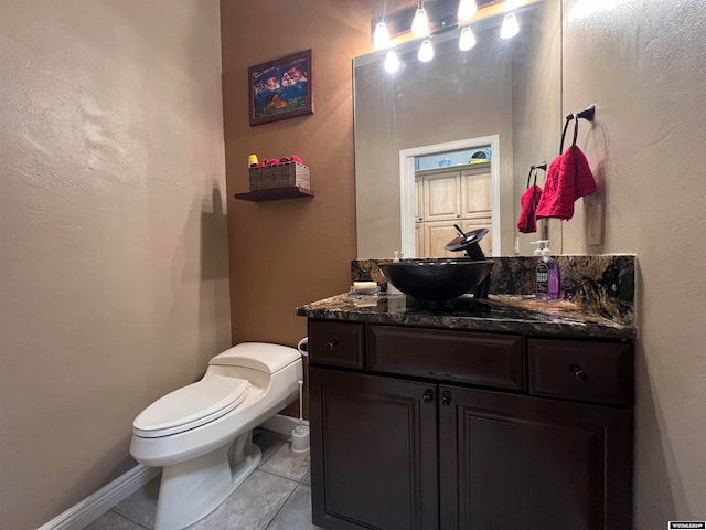 bathroom featuring vanity, tile patterned floors, and toilet