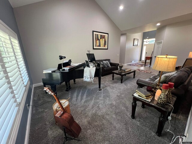 carpeted living room with high vaulted ceiling