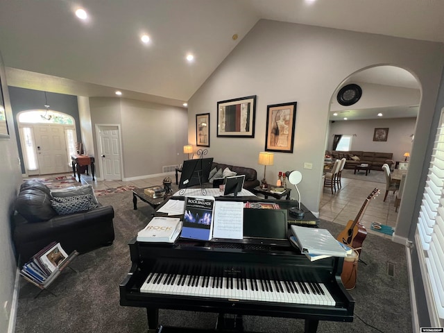 misc room with carpet and high vaulted ceiling