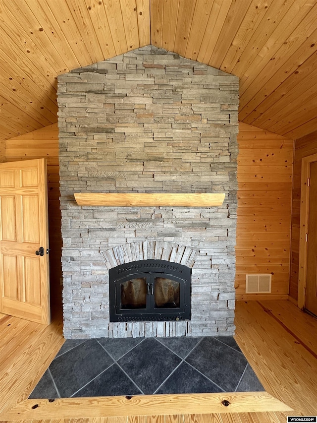 details with wood ceiling, visible vents, wood walls, and wood finished floors