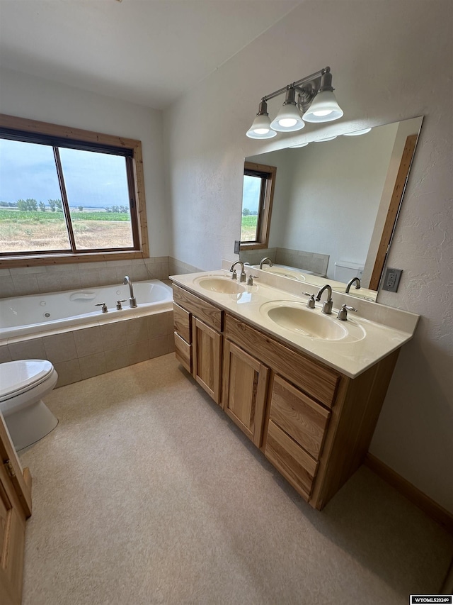 full bath featuring double vanity, a sink, toilet, and a bath