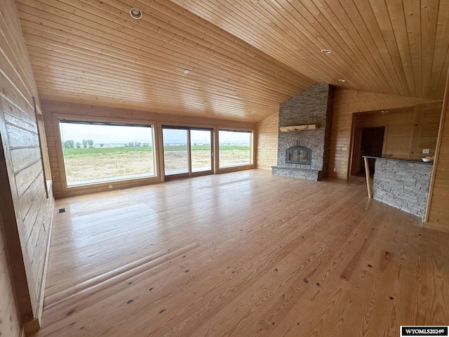 unfurnished living room with wood ceiling, a fireplace, vaulted ceiling, and wood finished floors