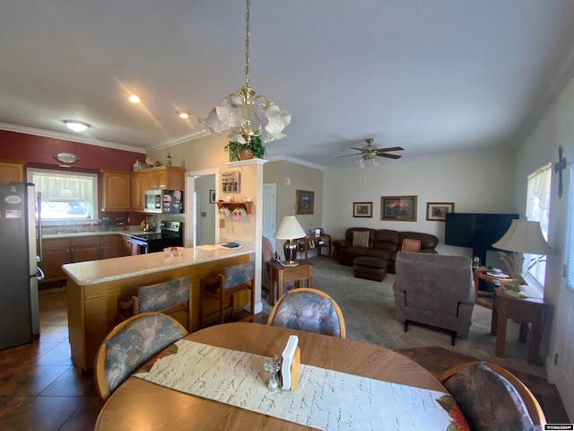 dining area with ceiling fan with notable chandelier, carpet, and ornamental molding