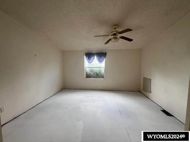 spare room with ceiling fan and a textured ceiling