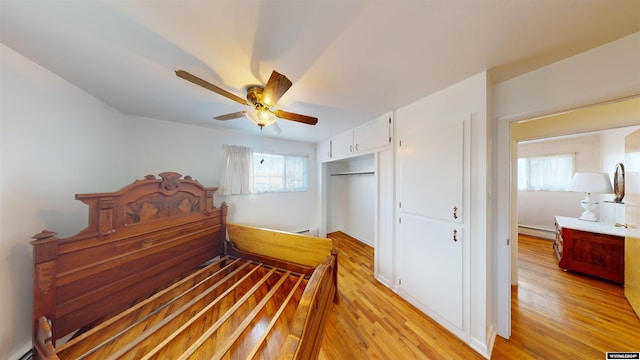 225 S 5th St, Lander, WY 82520 - bedroom featuring a baseboard radiator, a closet, a ceiling fan, and light wood finished floors