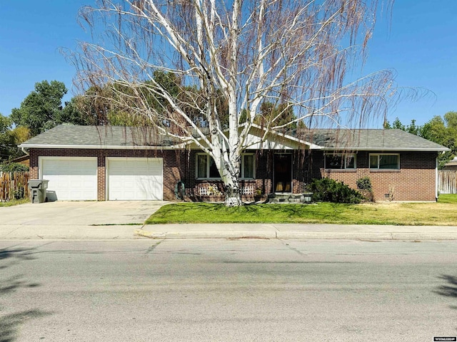 ranch-style house with a garage and a front yard