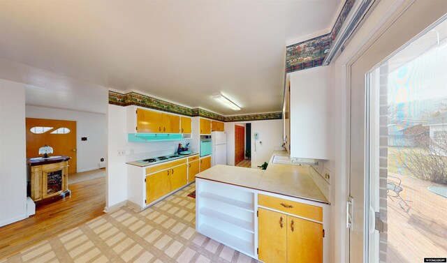 kitchen with white appliances and light wood-type flooring