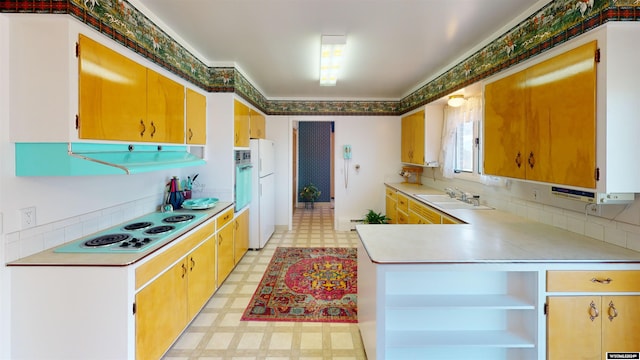 kitchen with sink, tasteful backsplash, white appliances, and light tile patterned floors