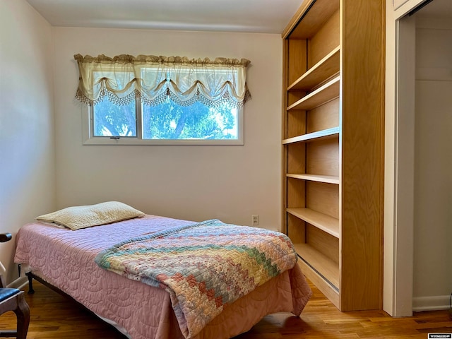 bedroom with a closet and wood-type flooring