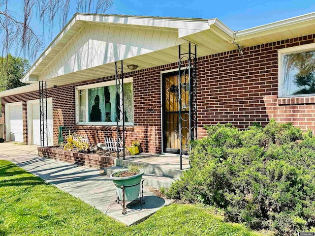 rear view of property with a garage and a porch