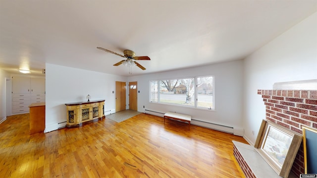 unfurnished living room featuring baseboard heating, wood-type flooring, and ceiling fan