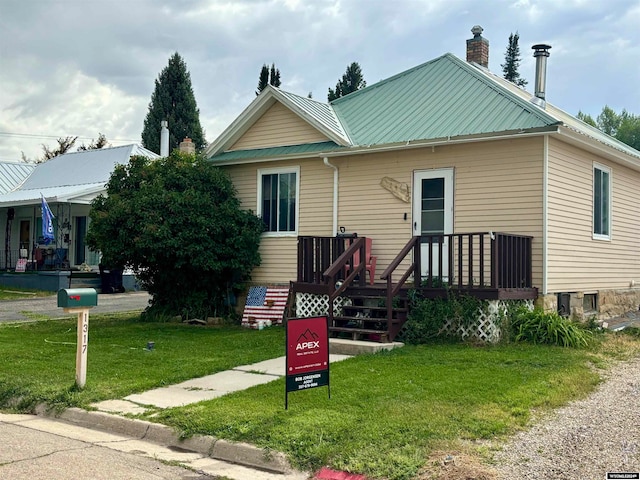 bungalow-style house featuring a front lawn