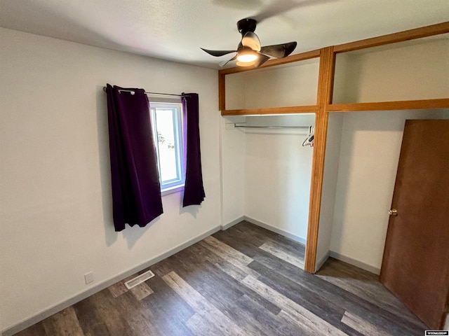 unfurnished bedroom with a closet, ceiling fan, and dark hardwood / wood-style floors