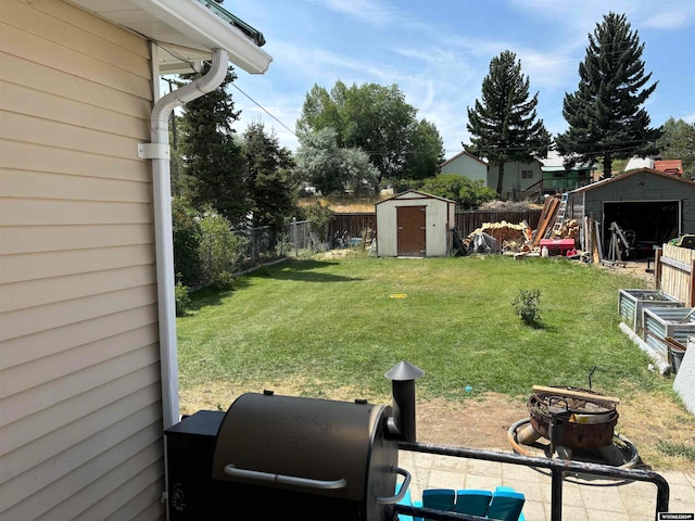 view of yard with a fire pit and a storage unit