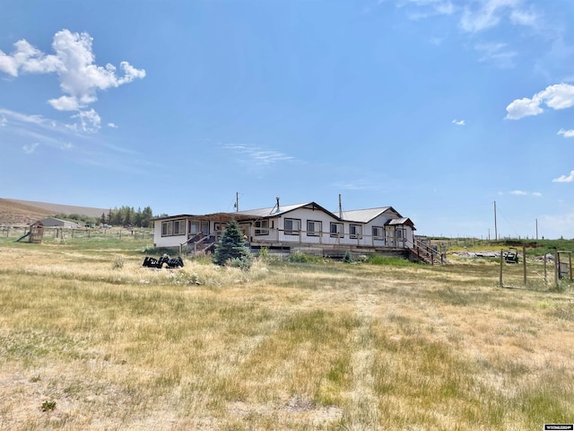 view of front of home with a rural view