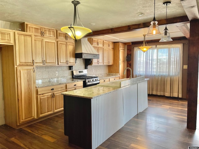 kitchen with dark hardwood / wood-style floors, stainless steel gas range oven, beamed ceiling, and custom exhaust hood