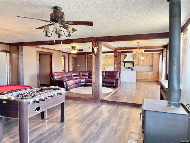 rec room featuring a textured ceiling, hardwood / wood-style floors, ceiling fan, beam ceiling, and billiards