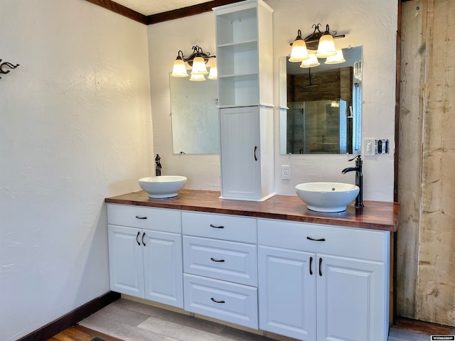 bathroom featuring dual vanity and ornamental molding