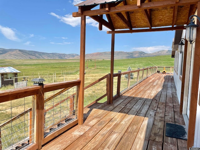 wooden deck featuring a rural view and a mountain view