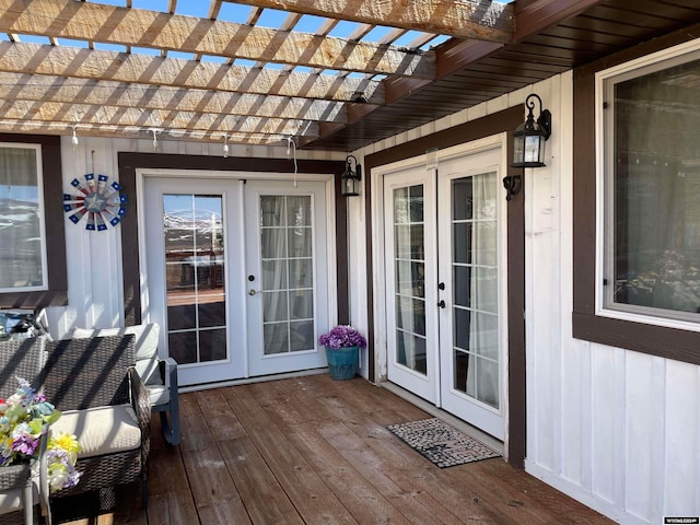 wooden terrace featuring french doors and a pergola