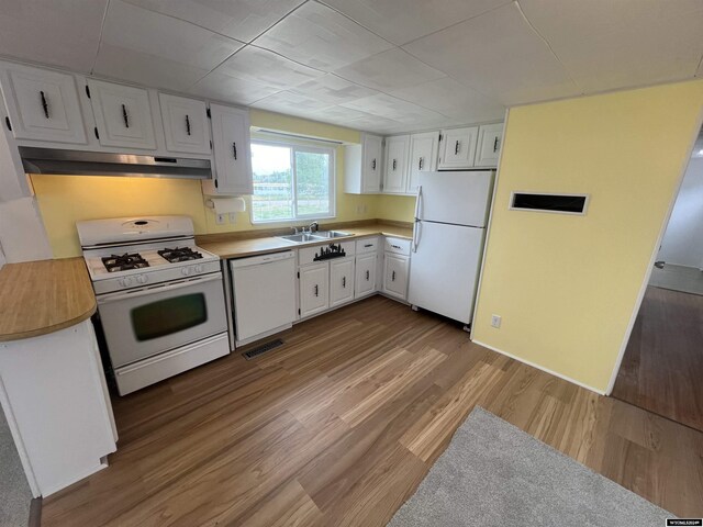 309 S Cherry, Pavillion, WY 82523 - kitchen with white cabinetry, sink, white appliances, and light hardwood / wood-style flooring