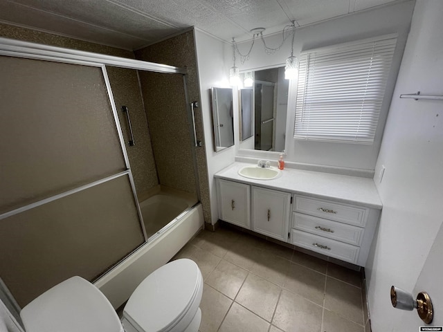 309 S Cherry, Pavillion, WY 82523 - full bathroom featuring tile patterned flooring, bath / shower combo with glass door, vanity, and toilet