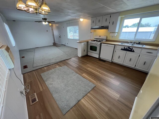 309 S Cherry, Pavillion, WY 82523 - kitchen featuring sink, white appliances, white cabinetry, decorative light fixtures, and light wood-type flooring