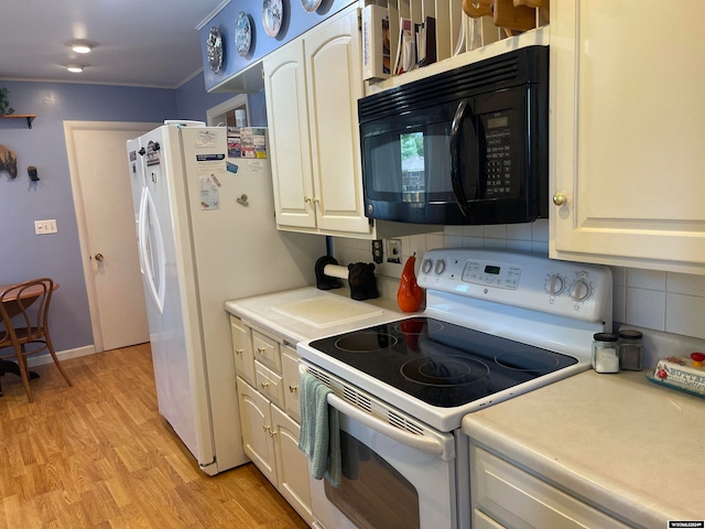 kitchen with light hardwood / wood-style flooring, white appliances, crown molding, and white cabinetry