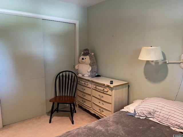 bedroom with light carpet and a closet