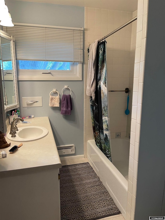 bathroom with shower / bath combo with shower curtain, vanity, and tile patterned flooring