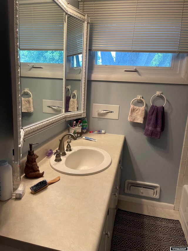 bathroom featuring vanity, a wealth of natural light, and tile patterned flooring