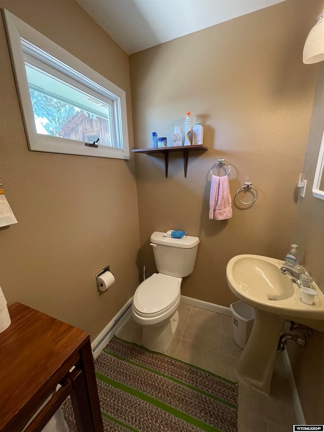 bathroom featuring toilet and tile patterned flooring