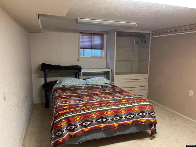 bedroom featuring a textured ceiling and carpet floors