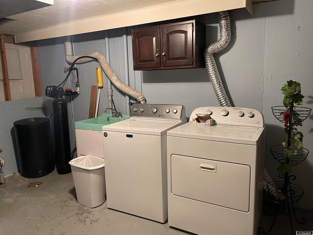 laundry area with cabinets and washing machine and dryer