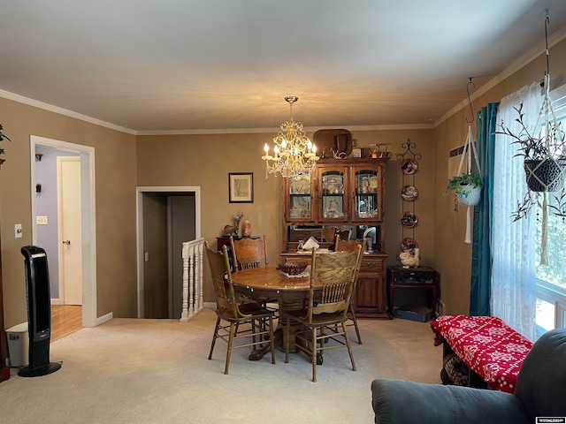 carpeted dining room featuring crown molding and a chandelier