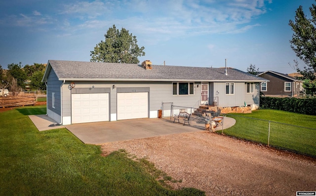 ranch-style home with a garage, a patio, and a front yard