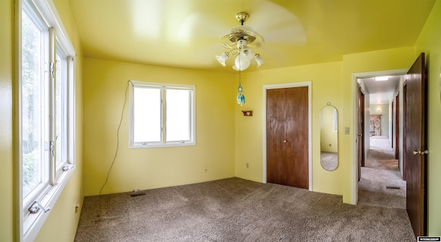 unfurnished bedroom featuring ceiling fan and carpet floors