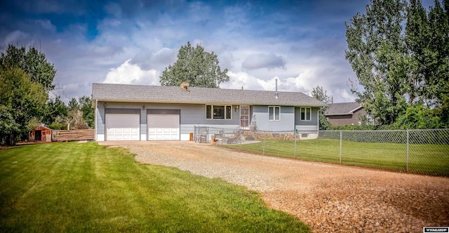 ranch-style house featuring a garage and a front yard