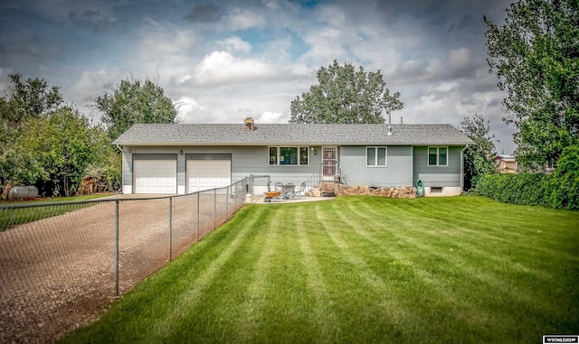 view of front of house featuring a garage and a front yard