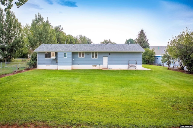 rear view of property with a yard