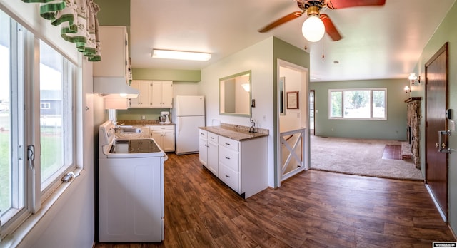 kitchen featuring dark carpet, white appliances, white cabinets, ceiling fan, and sink