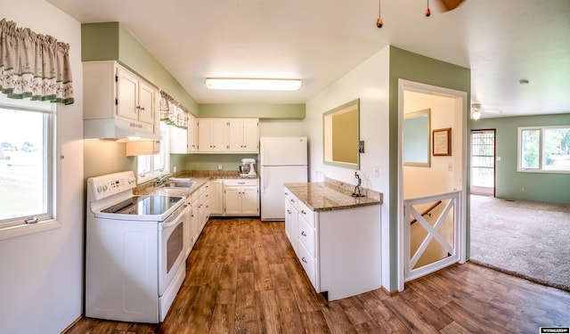 kitchen with dark carpet, white appliances, white cabinets, ceiling fan, and sink