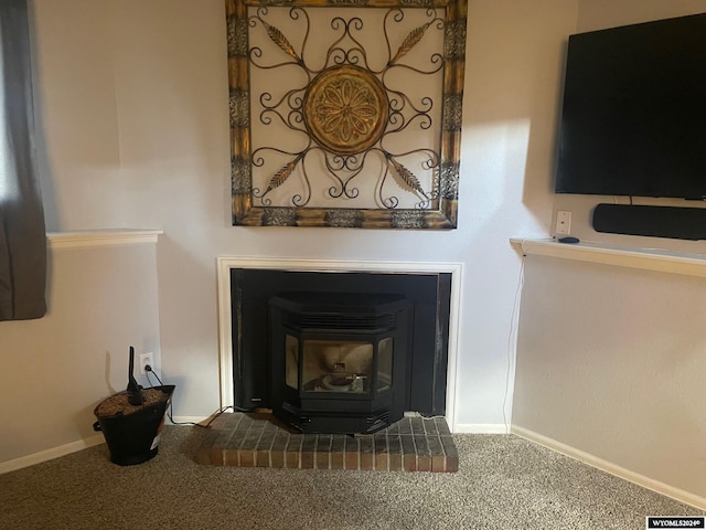 room details featuring a brick fireplace and carpet