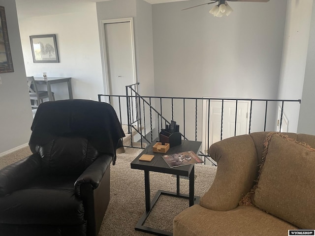 carpeted living room with ceiling fan