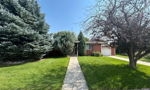 view of front of house with a garage and a front lawn