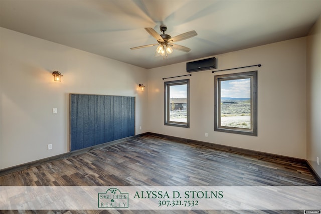 unfurnished room featuring ceiling fan, a wall mounted air conditioner, wood finished floors, and baseboards