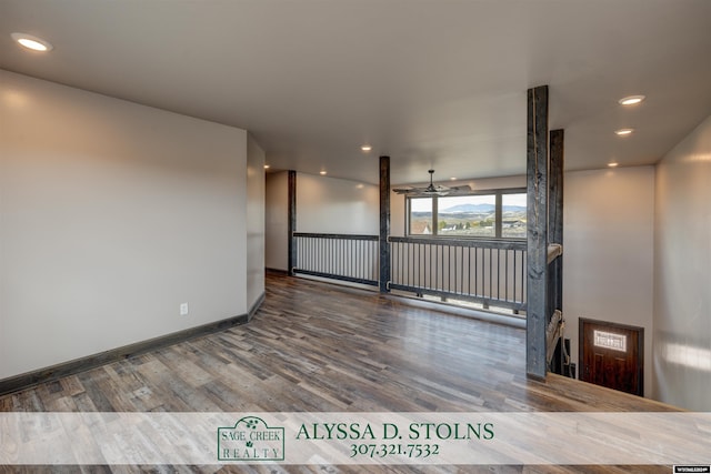 spare room with baseboards, wood finished floors, a ceiling fan, and recessed lighting