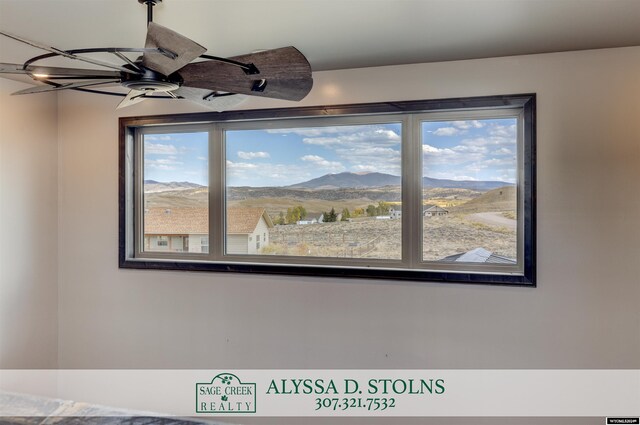 interior space with ceiling fan and a mountain view