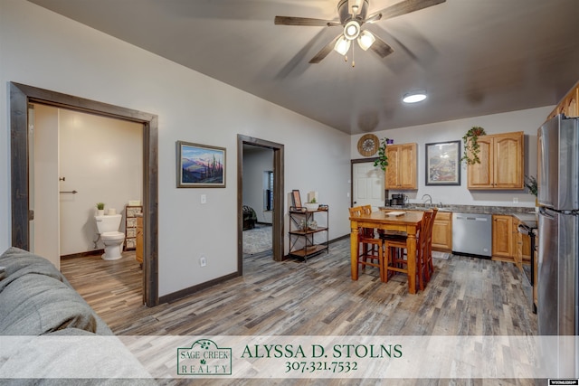 dining space featuring a ceiling fan, light wood-style flooring, and baseboards