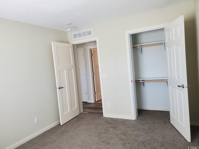 unfurnished bedroom featuring carpet and a closet